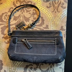 Coach wristlet with 2 zippered compartments.  7 1/2 inches by 4 1/2 inches